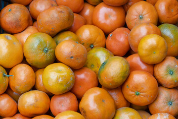 Fresh mandarin oranges on the vendor's counter