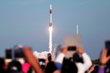 crowd watching rocket launch with smartphones - Powered by Adobe