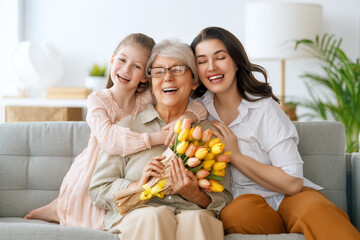 child, mother and granny with flowers