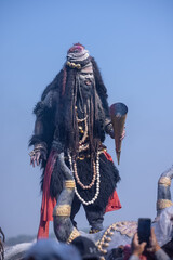 Masan Holi, Portrait of an male artist act as lord shiv with dry ash on face and body also in air...