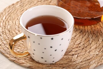 Aromatic tea in cup on table, closeup