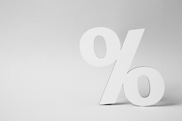 White percent sign on light grey background. Space for text