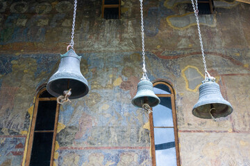 Three bells and frescoes on the wall of the church. Vardzia is a cave monastery, an ancient...