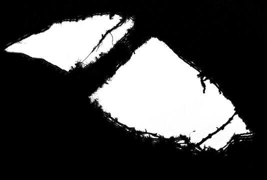 Tear in Jeans. Ripped Denim. old navy blue denim background with torn holes in middle of a round shape, torn material. gap in Jeans. Fabric texture backdrop.