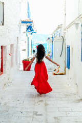 vacation mood. brunette woman in red summer dress