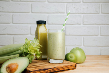 Fruit and vegetable smoothies in glass. Green smoothie on a wooden table. The concept of healthy eating. Front view