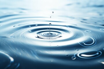 Close-up of a water droplet creating ripples on surface
