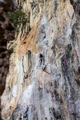 Jeune femme caucasienne brune escaladant une falaise en Tha&iuml;lande