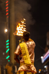 Ganga aarti, Portrait of young priest performing holy river ganges evening aarti at dashashwamedh...