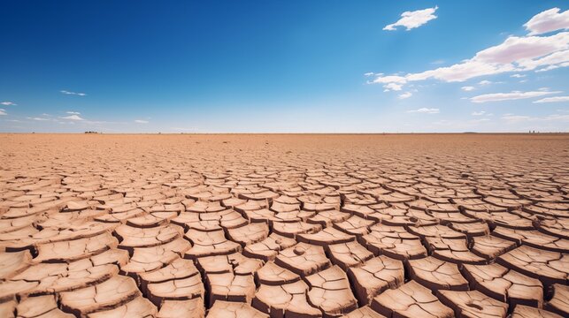 Cracked dry earth under blue sky