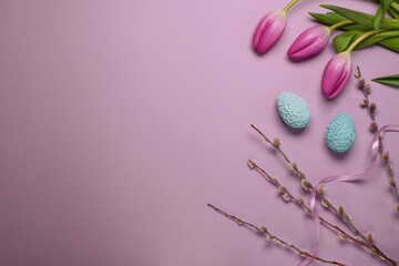 Easter holiday greeting, tilips, eggs, pussy willow. Spring season on pastel color. Top view, flat...