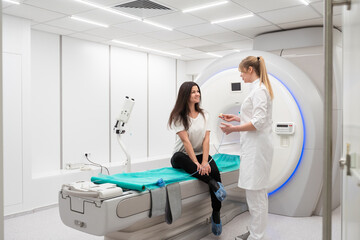 Medical CT or MRI Scan with a patient in the modern hospital laboratory. Interior of radiography department. Technologically advanced equipment in white room. Magnetic resonance diagnostics machine - obrazy, fototapety, plakaty