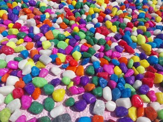 Beautiful multi-colored small rocks and pebbles. Colorful stones in different size and colors. Decorative item.