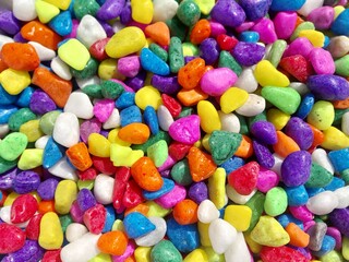 Beautiful multi-colored small rocks and pebbles. Colorful stones in different size and colors. Decorative item.