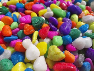Beautiful multi-colored small rocks and pebbles. Colorful stones in different size and colors. Decorative item.