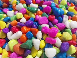 Beautiful multi-colored small rocks and pebbles. Colorful stones in different size and colors. Decorative item.