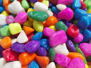 Beautiful multi-colored small rocks and pebbles. Colorful stones in different size and colors. Decorative item.