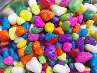 Beautiful multi-colored small rocks and pebbles. Colorful stones in different size and colors. Decorative item.