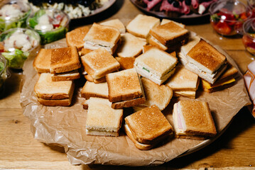 Assorted Sandwich Platter for Events. A selection of freshly made sandwiches with various fillings on a platter, ideal for parties, meetings, or casual dining events.