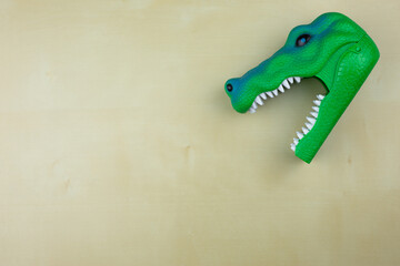 Plastic green dinosaur head with open mouth