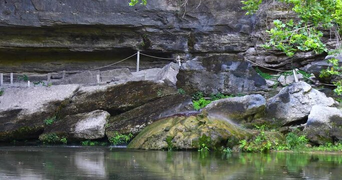 This is a static video of water dripping on rocks at the Hamilton Pool Preserve
