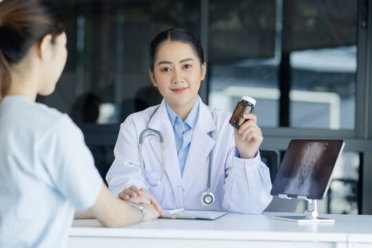 Asian female doctor explain to patient indoors office, healthcare and medical concept.