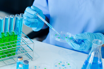 Asian female scientist or medical technician working with a blood lab test in the research lab, Healthcare and medical concept.