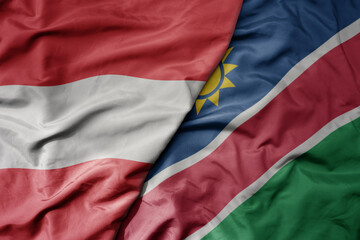 big waving national colorful flag of namibia and national flag of austria .