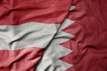 big waving national colorful flag of bahrain and national flag of austria .