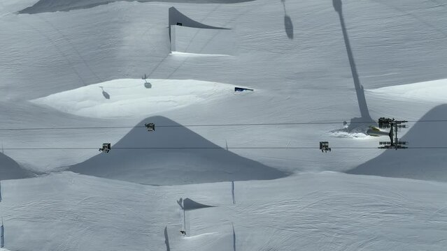 Aerial drone view of Madonna di Campiglio and ursus snowpark in Val Rendena dolomites trentino Italy. Snowboarder skier jumps on kicker in snowpack.
