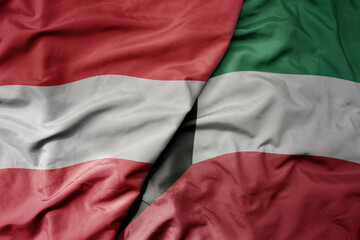 big waving national colorful flag of kuwait and national flag of austria .