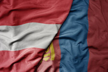 big waving national colorful flag of mongolia and national flag of austria .