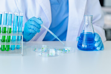 Asian female scientist or medical technician working with a blood lab test in the research lab,...