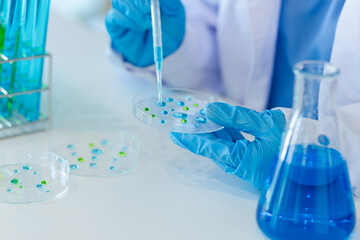 Asian female scientist or medical technician working with a blood lab test in the research lab,...