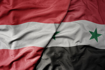 big waving national colorful flag of syria and national flag of austria .