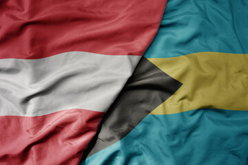 big waving national colorful flag of bahamas and national flag of austria .