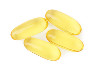 Many yellow vitamin capsules isolated on white, top view