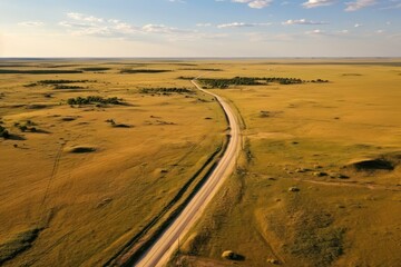 aerial view of road through prairie landscape in summer