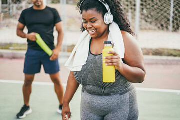 Plus size african girl smiling after sport workout routine - Healthy lifestyle and fitness for...