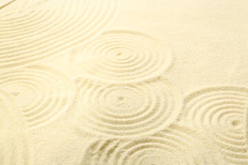 Fototapeta na wymiar Zen rock garden. Circle patterns on beige sand