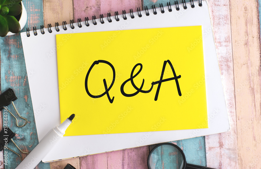Poster text q and a on yellow paper composition with stationery on color background