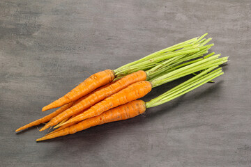 Young raw carrot heap isolated