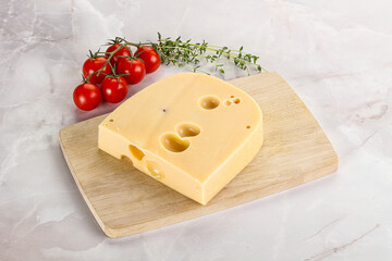 Maasdam cheese brick over board