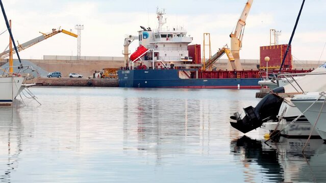 Loading grain into a ship, a ship for transporting grain. Wheat , natural materials transportation by water. work at the port export and import cargo business and logistics