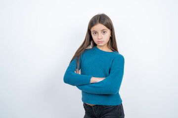 Serious pensive Young beautiful teen girl wearing blue T-shirt feel like cool confident entrepreneur cross hands.