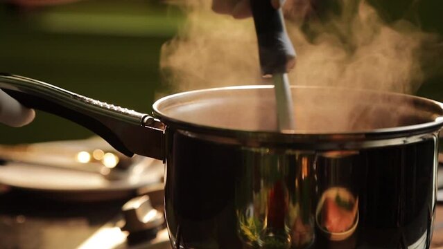 Chef cooking curry in pot