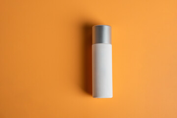 Cosmetic product in tube, bottle, lotion or serum seed on cream background. 
