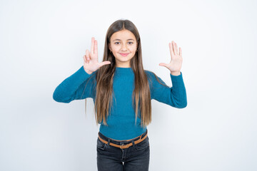 Obraz na płótnie Canvas Young beautiful teen girl wearing blue T-shirt showing and pointing up with fingers number eight while smiling confident and happy.