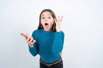 Angry Young beautiful teen girl wearing blue T-shirt screaming on the phone, having an argument with an employee. Troubles at work.