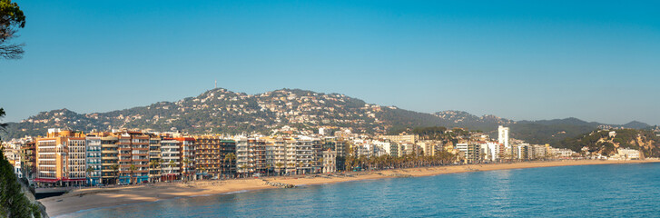Panoramic view of Lloret del Mar city. View of the most famous beach of Catalonia, Spain. Hills in...
